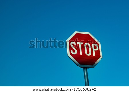 Stop road sign on a blue sky background