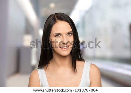 Head shot portrait smiling attractive woman looking at camera, beautiful young female