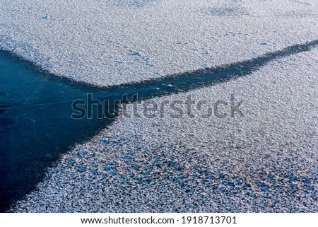 Texture of ice of frozen lake. Beautiful ice texture. snow abstract winter background wallpaper