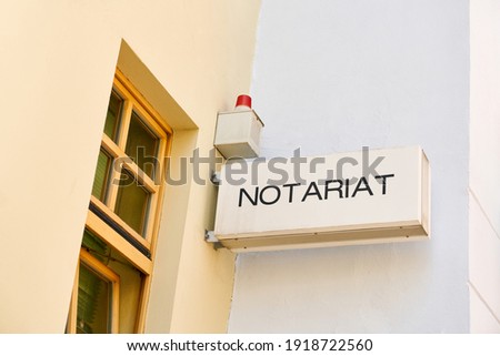 Notary's office sign with alarm system at the office of a notary
