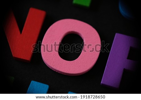 Color alphabet o on black background