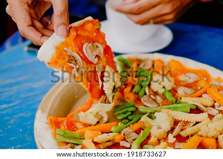 Slice of vegetables pizza served with sauce