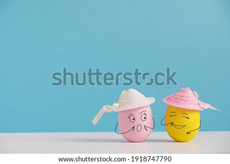 Happy eggs in hats laughing. Easter holiday concept with cute eggs with funny faces. Different emotions and feelings.
