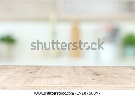 empty table board and defocused modern kitchen background. product display concept