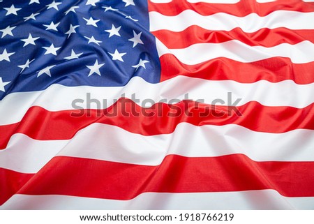 Close up of ruffled American flag. Satin texture curved flag of USA. Memorial Day or 4th of July. Banner, freedom concept