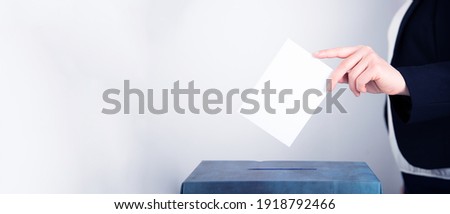 Banner of a voter putting vote in the ballot box. Election concept. Royalty-Free Stock Photo #1918792466