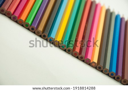 multicolored sticks on a gray background. colored pencils on light texture