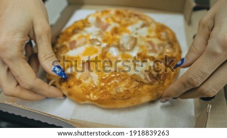 Girl eat pizza cheese four. Close up of young woman mouth greedily eating pizza and chewing in outdoor restaurant. Human hands taking pieces slices of hot tasty italian pizza from open box. Junk food.