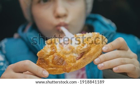 Child eat pizza cheese four. Close up of young girl woman mouth greedily eating pizza and chewing in outdoor restaurant. Kid children hands taking piece slice of hot tasty italian pizza from open box.
