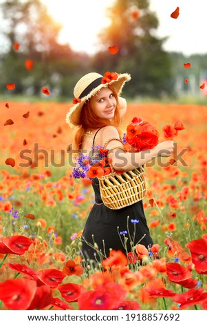 Stunning portrait of a beautiful young redhead woman in a black sundress  holding bouquet of red poppies. Flowers. Summer.  Fashion and beauty concept. 