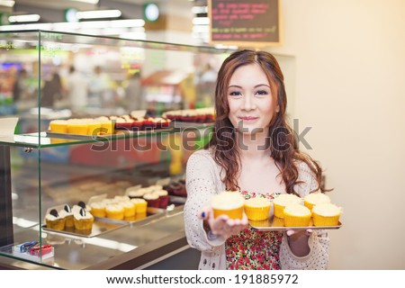 Pretty asian woman working at her own store