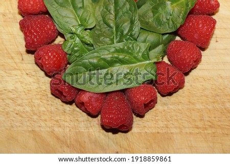 edible decoration sweet rapberry with baby spinach