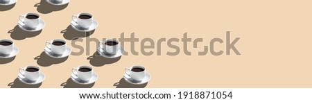 Set of coffee cups on saucer isolated on beige background seamless pattern with copy space.