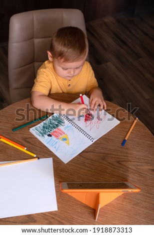 Little boy draws a picture