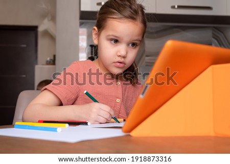 Girl doing homework. Online education. 