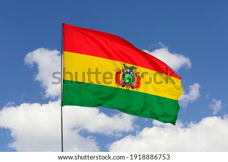 Bolivia flag isolated on the blue sky with clipping path. close up waving flag of Bolivia. flag symbols of Bolivia.