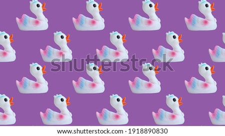 Duck rubber seamless pattern isolated on lilac background. Place for your text. Ducks seamless pattern on a lilac background. Duck background texture.