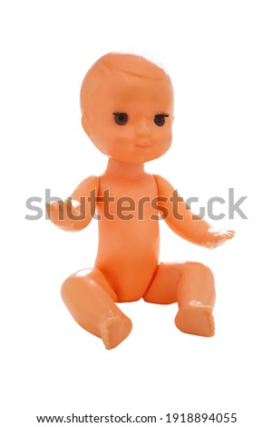 Old baby plastic doll on a white background. Toys for kids. Isolated