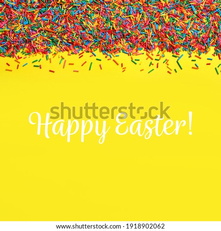 Text Happy Easter and bright colorful sprinkles on yellow background, flat lay. Confectionery decor
