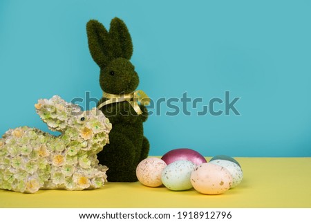 Easter rabbit toy bunny with painted eggs. Easter holiday concept