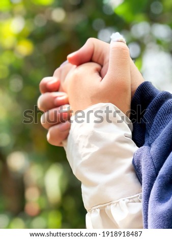 Holding hands with love on nature background. On love and forever concept.