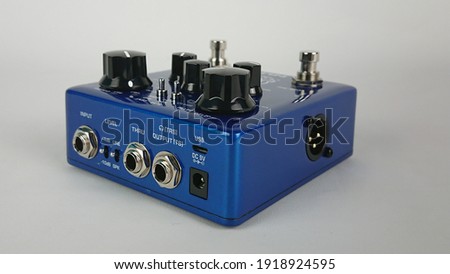Blue analog electric guitar effect isolated on white background. 