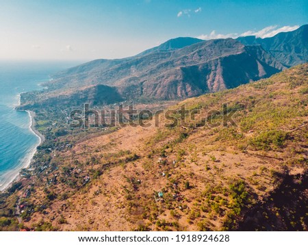 Aerial view with mountains nearly Amed village with Bali sea