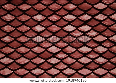 Red Abstract Background of earthenware tiles or calls tiles consists of fish scales on the roof of temple bangkok thailand - Backdrop Resource Design