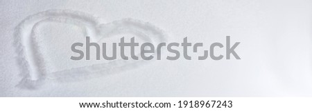 Snow heart drawing as winter background top view concept. Royalty-Free Stock Photo #1918967243