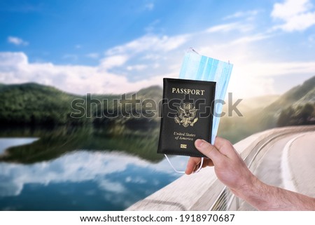 Man holding passport and protective mask outdoors, closeup. Travel during quarantine