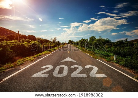2022 written on highway road with arrow in the middle of empty asphalt road and beautiful blue sky. Concept for vision 2021-2022. Royalty-Free Stock Photo #1918986302
