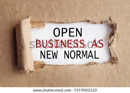 OPEN BUSINESS AS NEW NORMAL. text on white paper over torn paper background.
