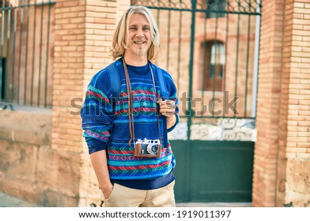Young scandinavian tourist man smiling happy at the city.