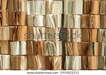 background in the form of unfolded paper books attached to the wall in a vintage style Royalty-Free Stock Photo #1919022551