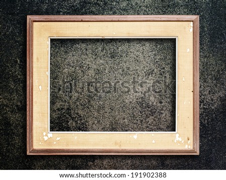 Old picture frame on grunge wall.