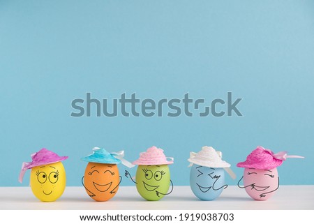 Happy eggs in hats laughing. Easter holiday concept with cute eggs with funny faces. Different emotions and feelings.