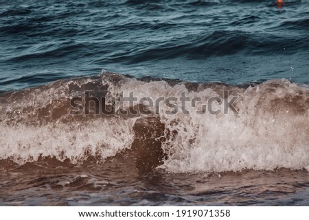 Breaking wave, splash of water.Beautiful blue sea during the wind.Summer beach