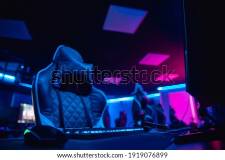 Workplace Professional gamers cafe room with powerful personal computer game chair blue color. Concept cyber sport arena.