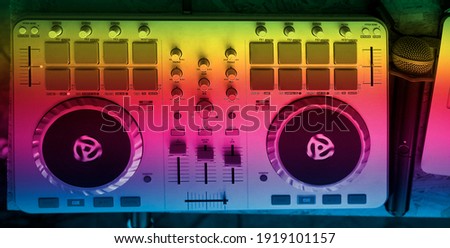 turntable console at stage in the night club.  sound mixer stationб microphone and laptop at club party. DJ mixer controller. 