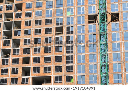 Crane and building from concrete and brick