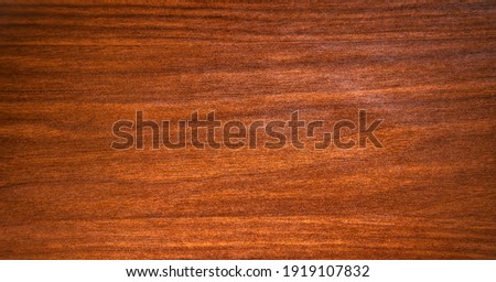 The texture is mahogany with stripes and splotches of black color
