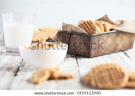 Fresh baked, homemade peanut butter cookies. Selective focus on cookie in antique pan in center with blurred foreground and background.