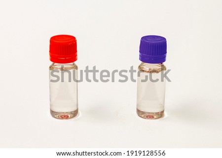 two bottles with red and blue cap
