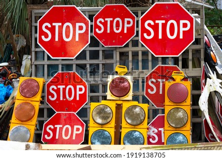 Stop signs and traffic signals at a flea market.