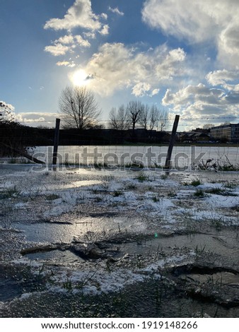 Frozen flooded field in Walthamstow Marshes in winter London lockdown