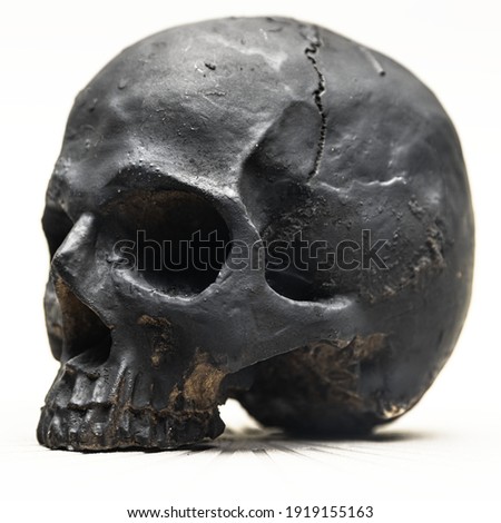 Spooky dark black skull aginast white background isolated