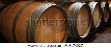 wooden wine barrels in wine cellar. Concept Product Banner. High quality photo