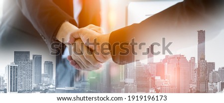 Double exposure Business people of Marketing team with a Partnership greeting power tag team,Teamwork Join Hands Partnership Concept after complete deal,Successful Teamwork Partnership in the city. Royalty-Free Stock Photo #1919196173