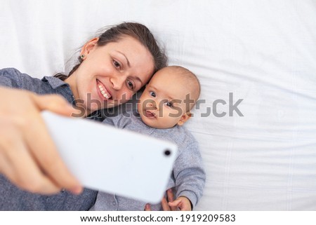 Happy mom and daughter take a selfie
