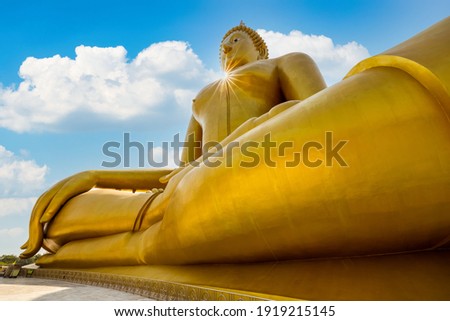 big golden Buddha statue and blue sky over the sun light background in ang thong Thailand low angle view 